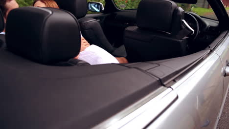 Romantic-couple-kissing-in-a-convertible-car