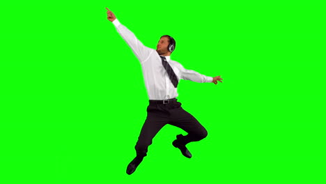 Businessman-listening-to-music-while-jumping-up-disco-dancing