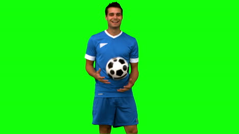 Man-juggling-a-football-on-green-screen