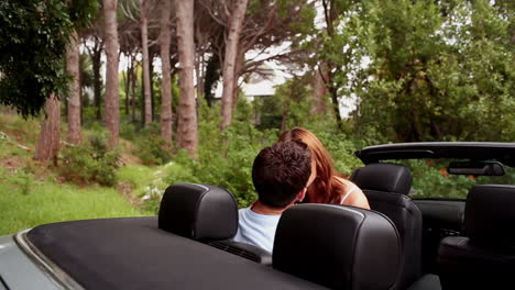 Romantic-couple-kissing-in-a-convertible-car-