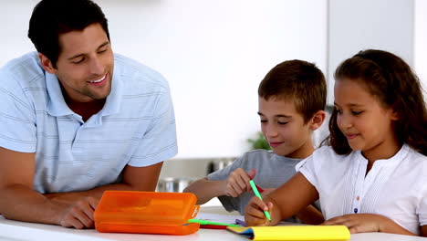 Father-watching-his-children-draw