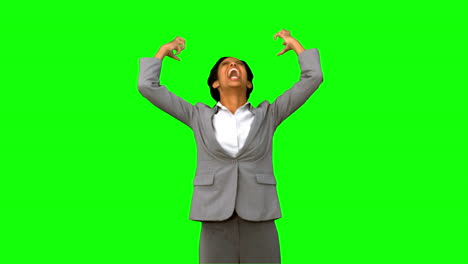 Furious-businesswoman-raising-arms-on-green-screen