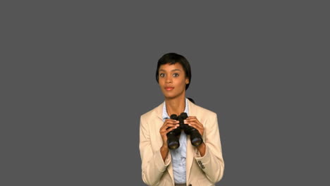 Businesswoman-jumping-while-holding-binoculars