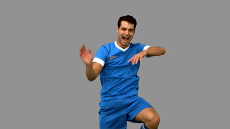 Football-player-celebrating-a-goal-on-grey-screen
