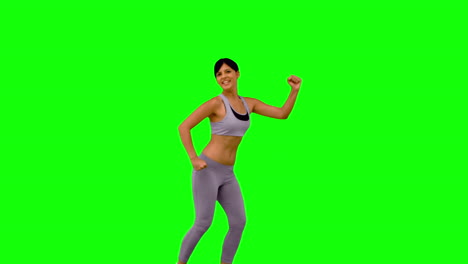 Athletic-woman-leaping-and-posing-on-green-screen