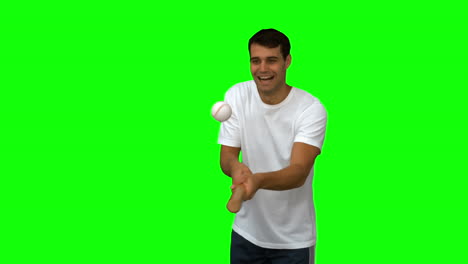 Man-dribbling-with-a-baseball-on-green-screen