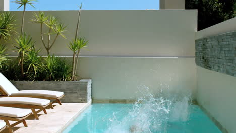 Brother-and-sister-diving-into-the-swimming-pool