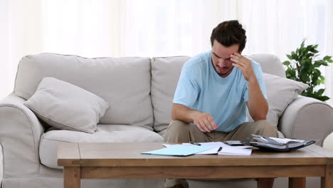 Stressed-man-sitting-on-sofa-