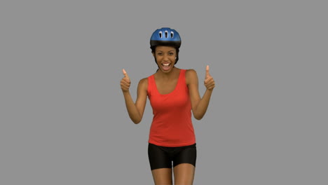 Cyclist-woman-giving-thumbs-up-on-grey-screen