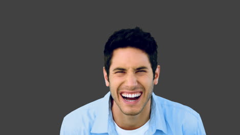 Man-laughing-at-the-camera-on-grey-background