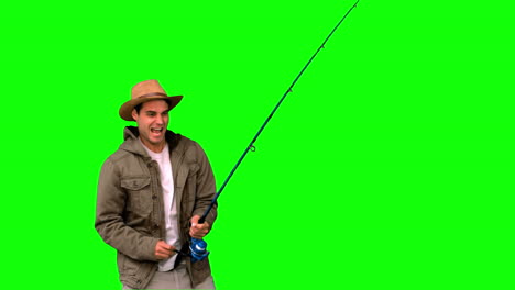 Man-making-effort-while-fishing-on-green-screen