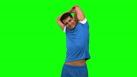 Football-player-stretching-arms-on-green-screen