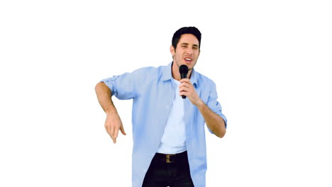 Man-singing-into-microphone-and-dancing-on-white-background