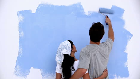 Lovely-couple-painting-a-wall