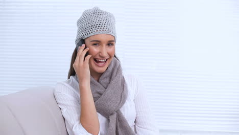 Young-woman-with-hat-and-scarf-calling-someone-