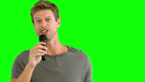 Man-with-microphone-singing-on-green-screen