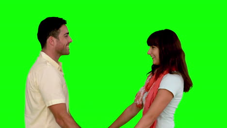 Young-couple-cuddling-on-green-screen