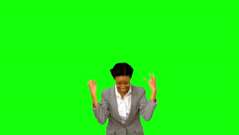 Pretty-businesswoman-raising-arms-on-green-screen