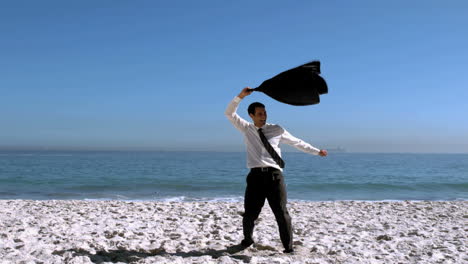 Hombre-De-Negocios-Desnudándose-Y-Luego-Arrojando-Su-Chaqueta-A-La-Playa