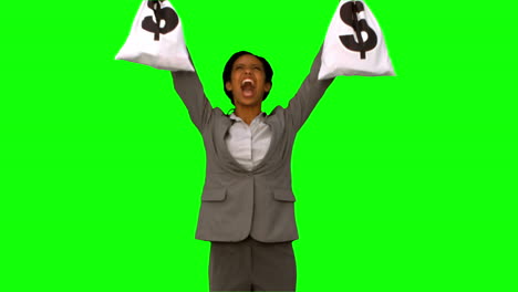 Businesswoman-holding-money-bags-on-green-screen