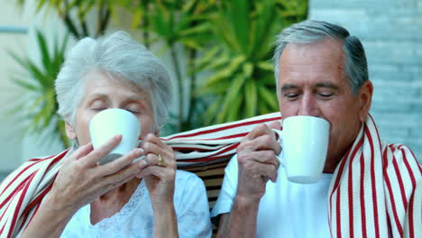 Retired-couple-enjoying-coffee-outside