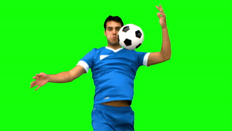 Handsome-man-controlling-a-football-with-his-chest-on-green-screen-