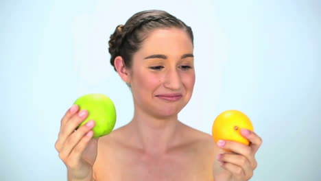 Young-woman-showing-fruits-at-camera