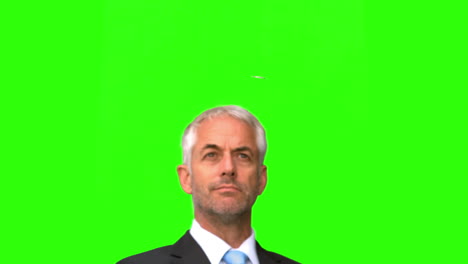 Businessman-throwing-a-coin-in-the-air-on-green-screen