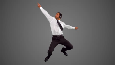 Businessman-jumping-and-listening-to-music-and-disco-dancing