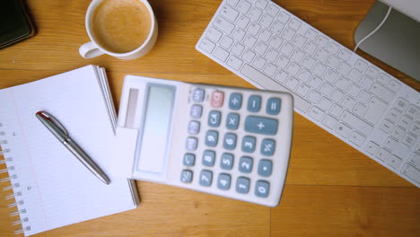 Pocket-calculator-falling-on-office-desk