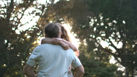 Smiling-man-holding-his-wife-and-turning-