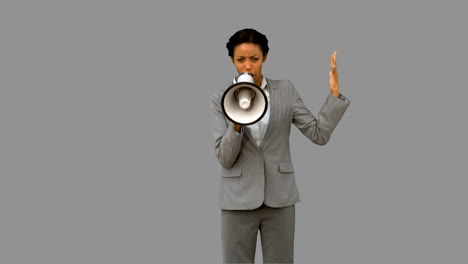 Businesswoman-yelling-into-a-megaphone-on-grey-screen