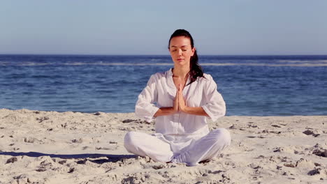 Brunette-woman-meditating-in-sukhasana-pose