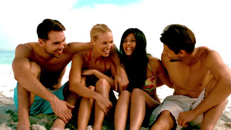 Friends-laughing-and-chatting-together-on-the-beach