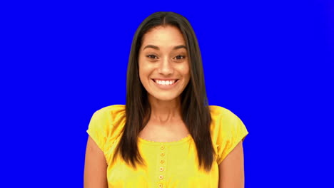 Cheerful-woman-being-surprised-on-blue-screen