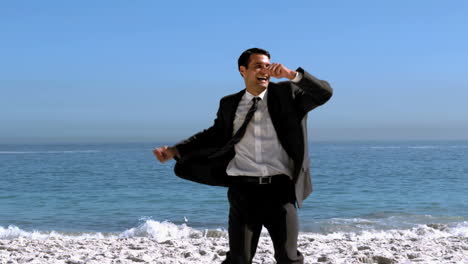 Free-happy-businessman-dancing-on-the-beach