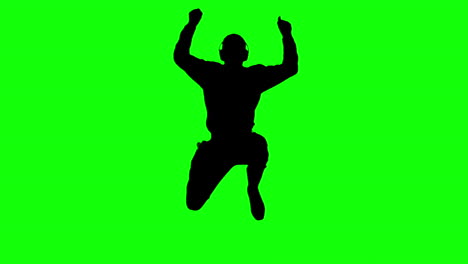 Silhouette-of-a-man-enjoying-music-and-jumping-on-green-screen