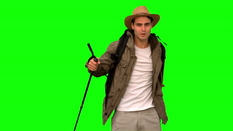 Man-wiping-his-forehead-while-he-is-trekking-on-green-screen-