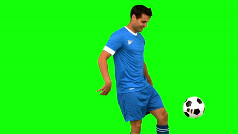 Handsome-man-juggling-a-football-on-green-screen