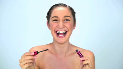 Young-woman-applying-mascara-on-her-eyelash