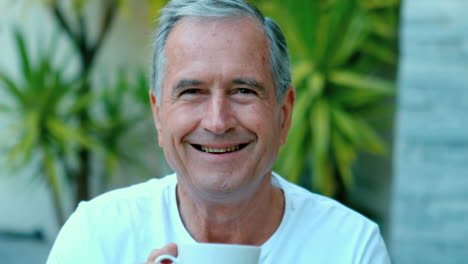 Retired-man-enjoying-coffee-outside