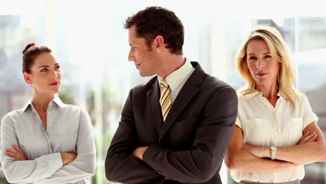 Three-smiling-business-people-standing