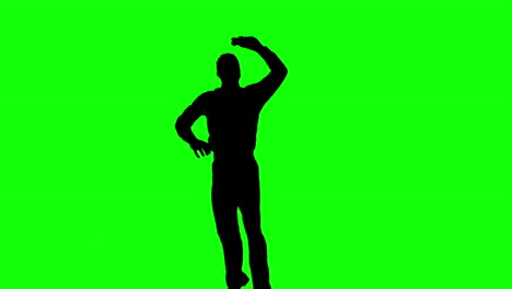 Silhouette-Eines-Springenden-Mannes,-Der-Sich-Auf-Einem-Grünen-Bildschirm-Dreht
