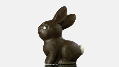 Chocolate-rabbit-falling-and-bouncing-onto-white-surface