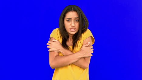 Woman-shivering-with-cold-on-blue-screen