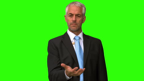 Elegant-businessman-throwing-a-coin-in-the-air-on-green-screen