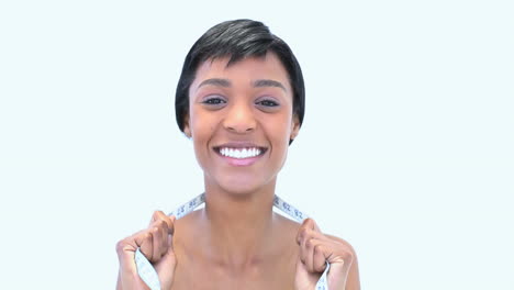 Young-woman-holding-a-measuring-a-tape-around-her-neck