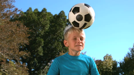 Young-boy-heading-a-football