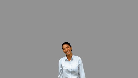 Cheerful-businesswoman-raising-arms-on-grey-screen-in-slow-motion