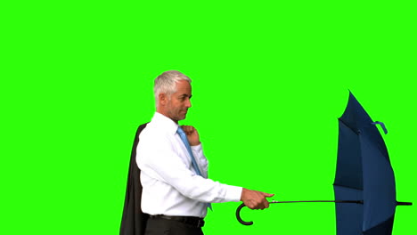Businessman-going-under-his-umbrella-on-green-screen